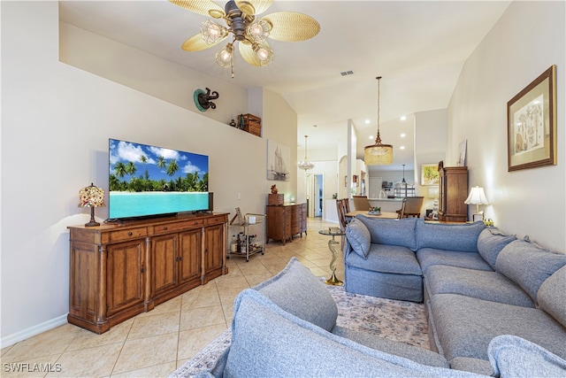 living room featuring ceiling fan with notable chandelier and light tile patterned floors