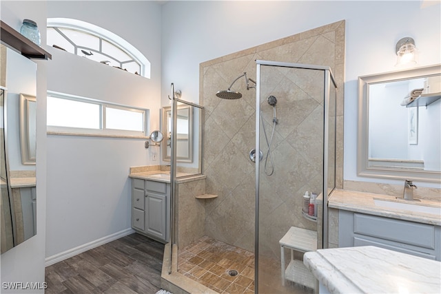 bathroom with vanity, hardwood / wood-style floors, and a tile shower