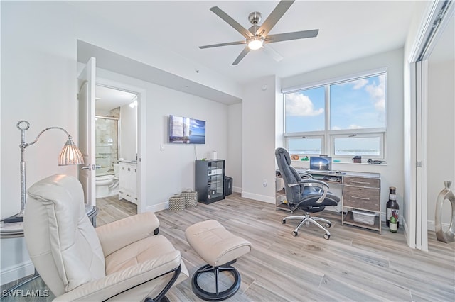 home office featuring light hardwood / wood-style floors and ceiling fan