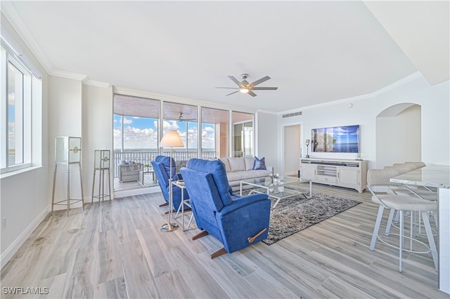 living room with ceiling fan, ornamental molding, and light hardwood / wood-style flooring