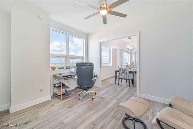 home office featuring light hardwood / wood-style floors and ceiling fan