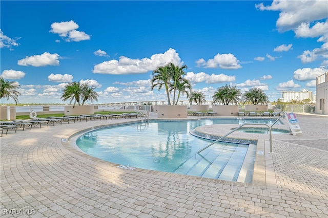 view of pool with a patio and a community hot tub