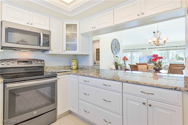 kitchen featuring tasteful backsplash, appliances with stainless steel finishes, and white cabinets