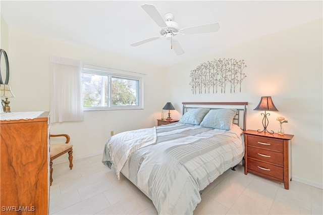 tiled bedroom featuring ceiling fan