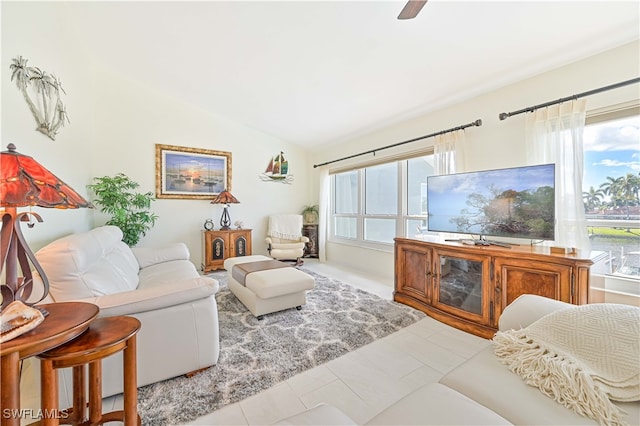 tiled living room featuring vaulted ceiling and plenty of natural light