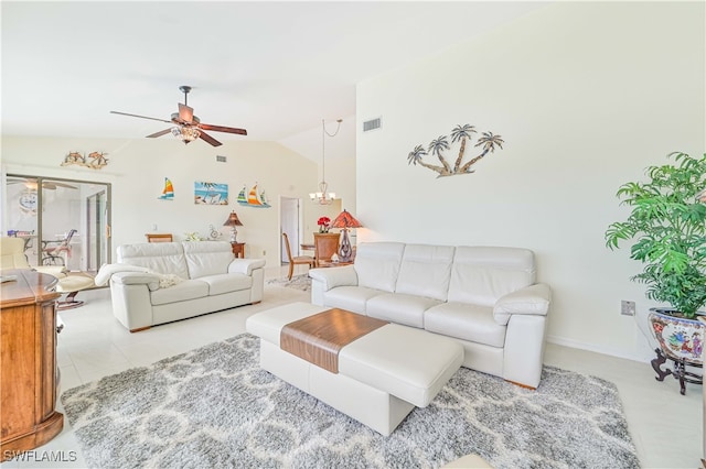 living room featuring lofted ceiling, light tile patterned flooring, and ceiling fan with notable chandelier