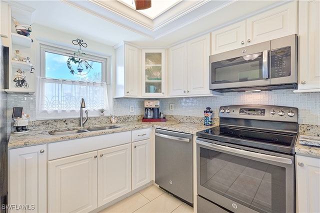 kitchen featuring stainless steel appliances, backsplash, sink, crown molding, and white cabinets