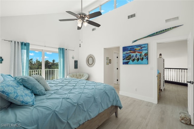 bedroom featuring high vaulted ceiling, ceiling fan, light hardwood / wood-style floors, and access to outside