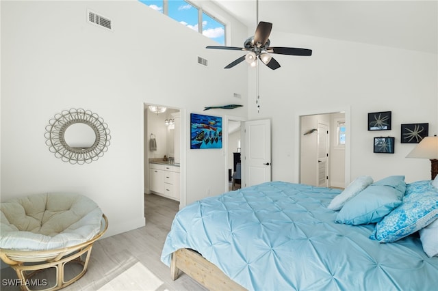 bedroom with hardwood / wood-style floors, connected bathroom, high vaulted ceiling, and ceiling fan