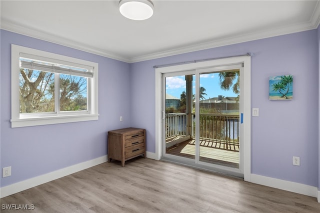 spare room with wood-type flooring and ornamental molding