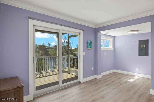 entryway featuring electric panel, a wealth of natural light, crown molding, and light hardwood / wood-style floors