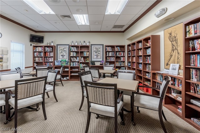 office area with carpet, a paneled ceiling, and crown molding