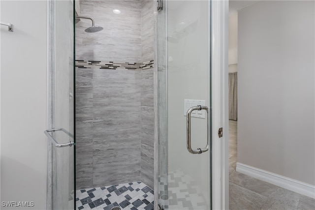 bathroom featuring a shower with door