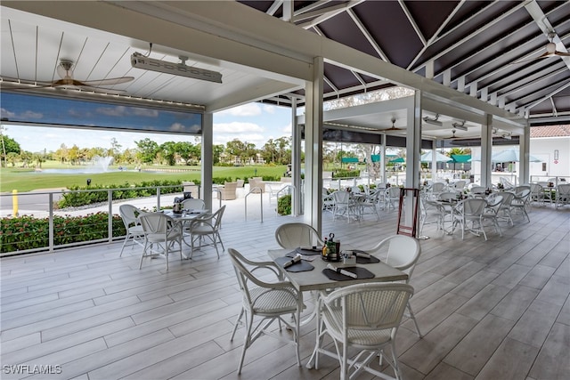 deck featuring a water view and ceiling fan