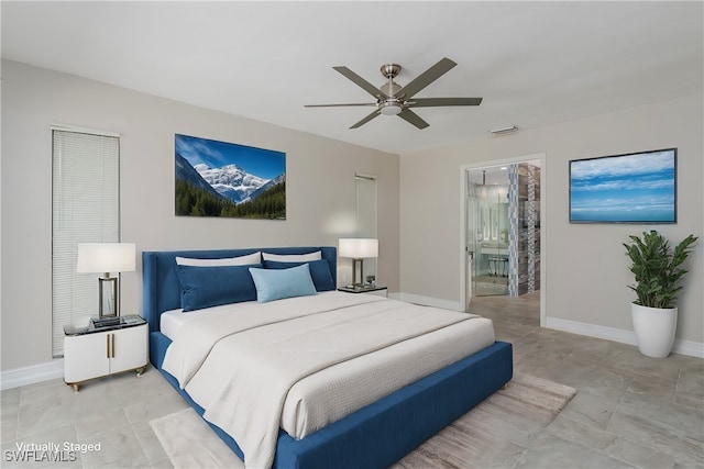 bedroom featuring ceiling fan and ensuite bath