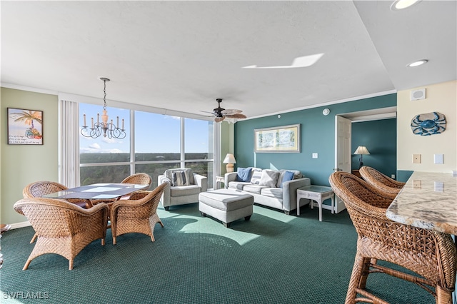 carpeted living room featuring ceiling fan with notable chandelier, a wall of windows, and ornamental molding