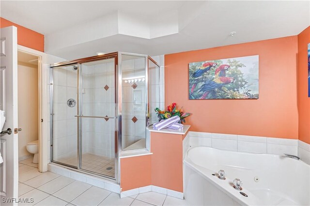 full bathroom with a jetted tub, tile patterned flooring, toilet, and a shower stall