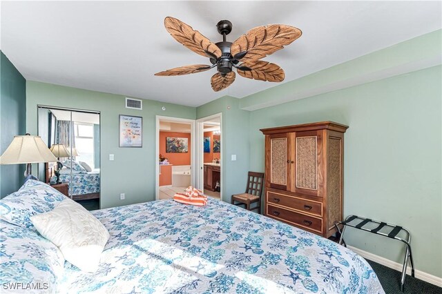 bedroom featuring baseboards, visible vents, ceiling fan, ensuite bathroom, and carpet