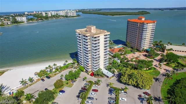 bird's eye view featuring a water view and a beach view