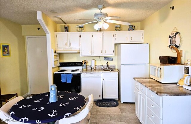 kitchen with ceiling fan, white appliances, a textured ceiling, and white cabinets