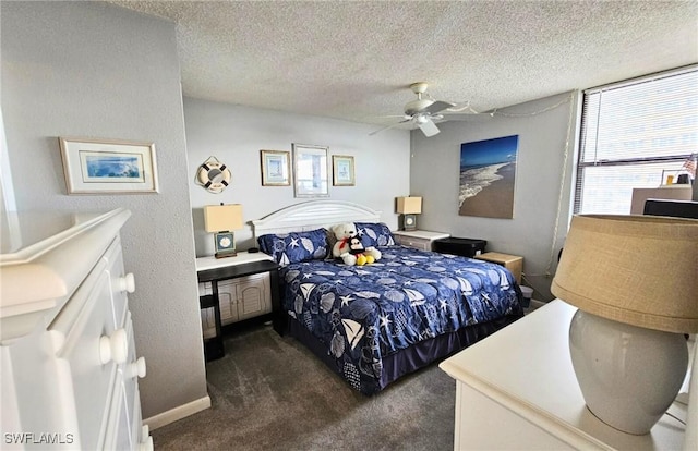 carpeted bedroom featuring ceiling fan and a textured ceiling