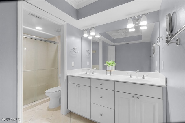 bathroom with vanity, toilet, a raised ceiling, and walk in shower