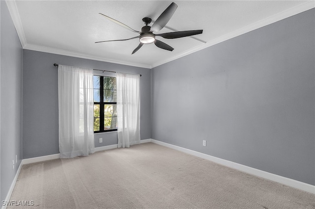 carpeted spare room with ornamental molding and ceiling fan