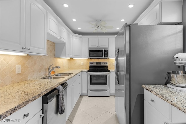 kitchen with sink, white cabinets, stainless steel appliances, and ceiling fan