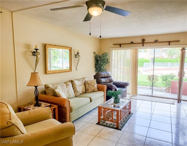 living room featuring ceiling fan, light tile patterned floors, and a wealth of natural light