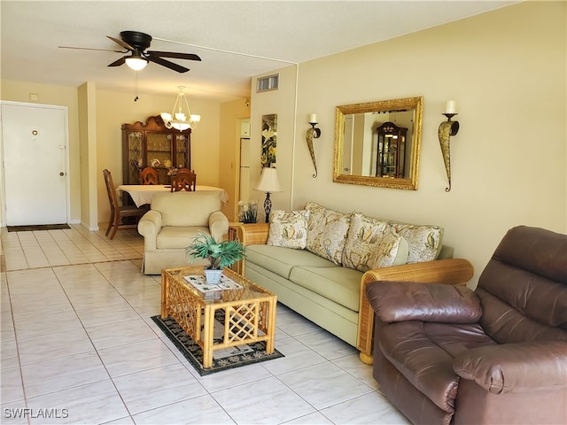 living room featuring ceiling fan with notable chandelier and light tile patterned floors