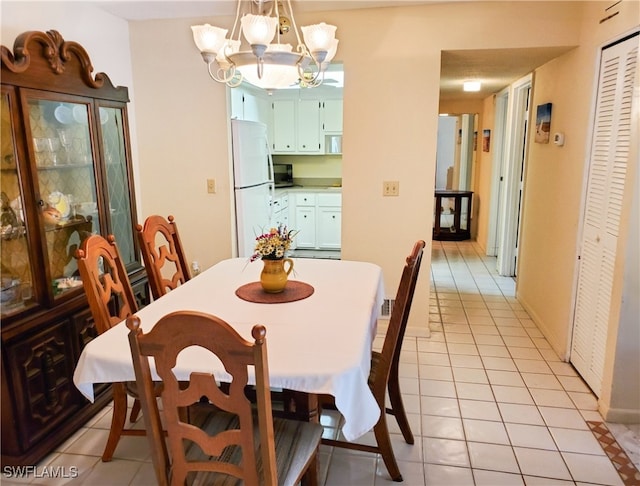 dining room with a notable chandelier and light tile patterned floors