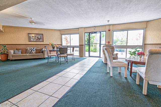 interior space with a textured ceiling and light colored carpet