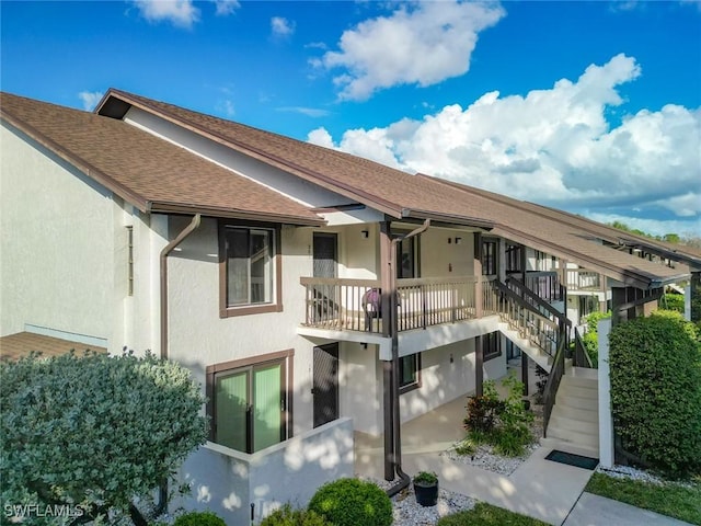 800 Misty Pines Cir Unit H-201, Naples, FL 34105 - rear view of property with stairway, stucco siding, and a shingled roof