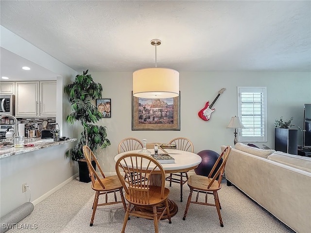 dining area with light carpet