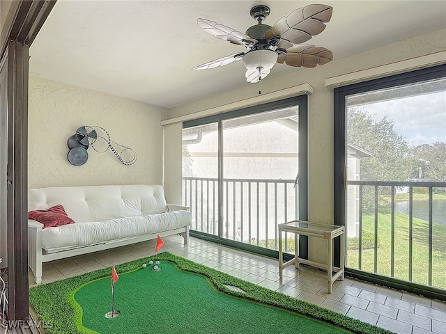 sunroom featuring ceiling fan