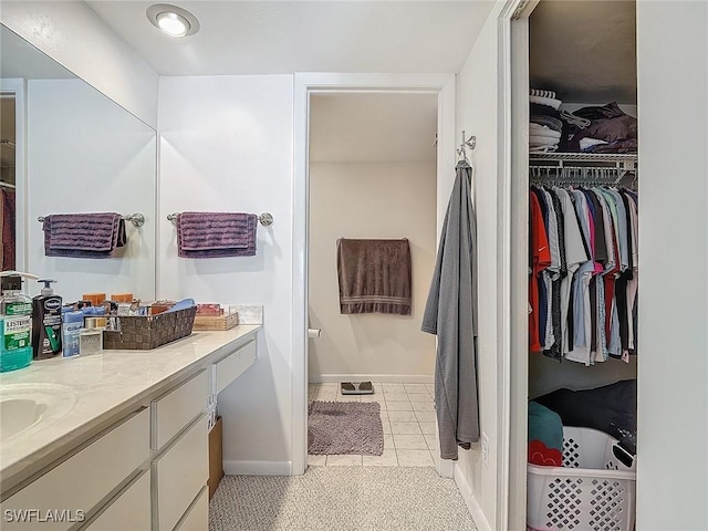 800 Misty Pines Cir Unit H-201, Naples, FL 34105 - full bath featuring baseboards, a walk in closet, vanity, and tile patterned floors