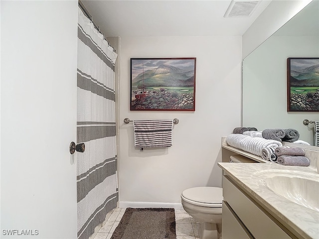 bathroom with tile patterned flooring, vanity, and toilet