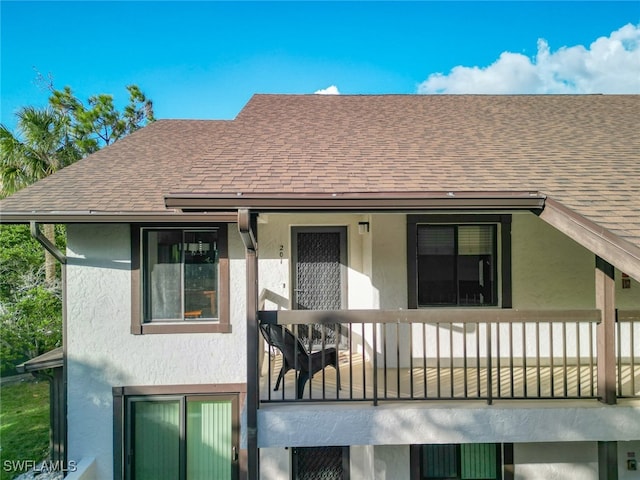 back of property featuring a balcony