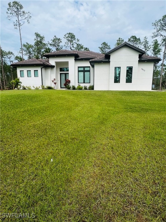 back of house featuring a yard