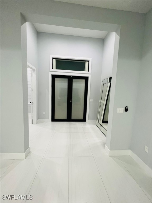 corridor featuring light tile patterned flooring