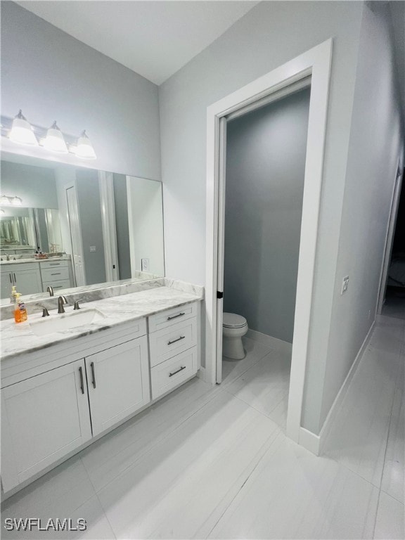 bathroom with vanity, toilet, and tile patterned flooring