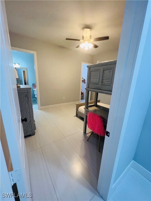 bedroom with light tile patterned floors and ceiling fan