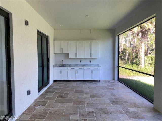 unfurnished sunroom featuring sink