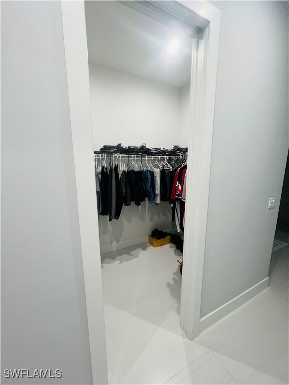 spacious closet with light tile patterned floors