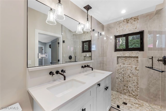 bathroom with vanity and a shower with door