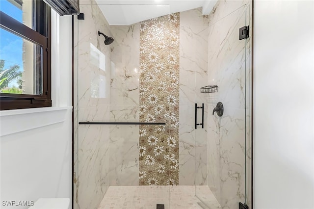 bathroom featuring a shower with shower door