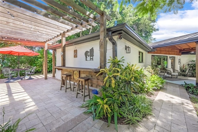 view of patio with a pergola and an outdoor bar