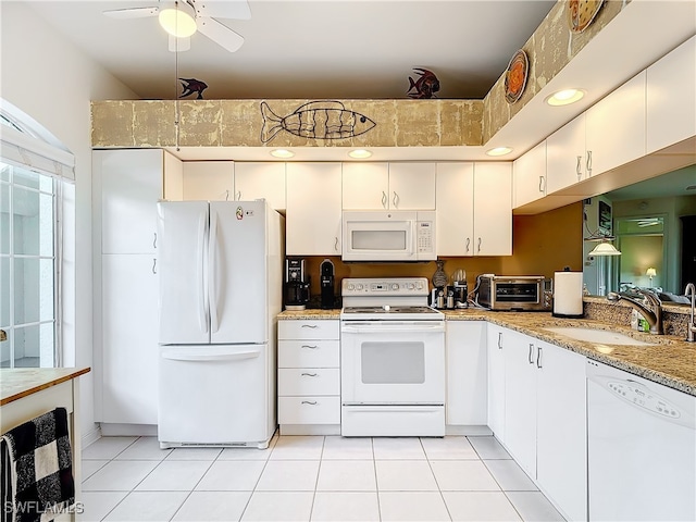 kitchen with white cabinets, ceiling fan, sink, and white appliances