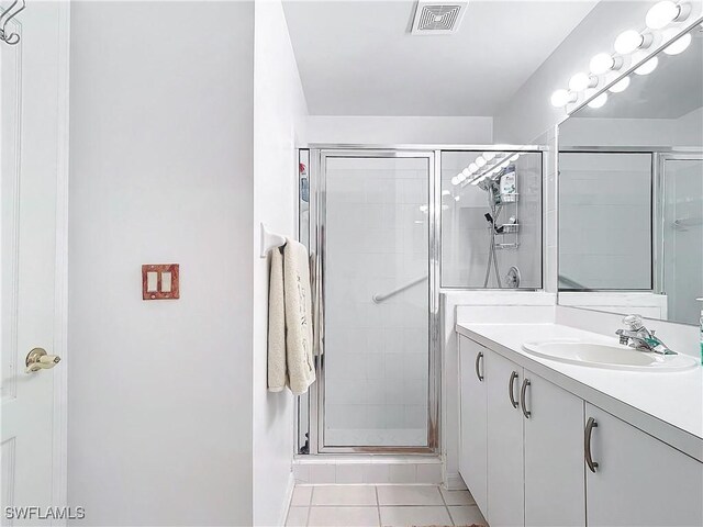 162 Newport Dr Unit 1202, Naples, FL 34114 - bathroom with a stall shower, tile patterned floors, and vanity