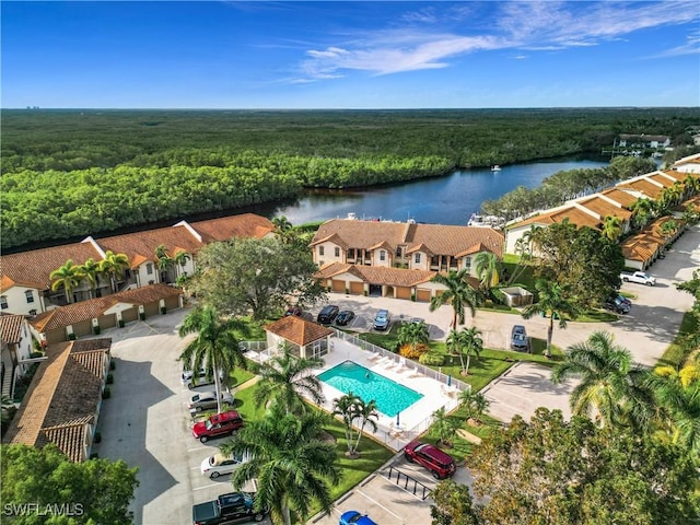 162 Newport Dr Unit 1202, Naples, FL 34114 - aerial view of residential area with a heavily wooded area, a nearby body of water, and a pool